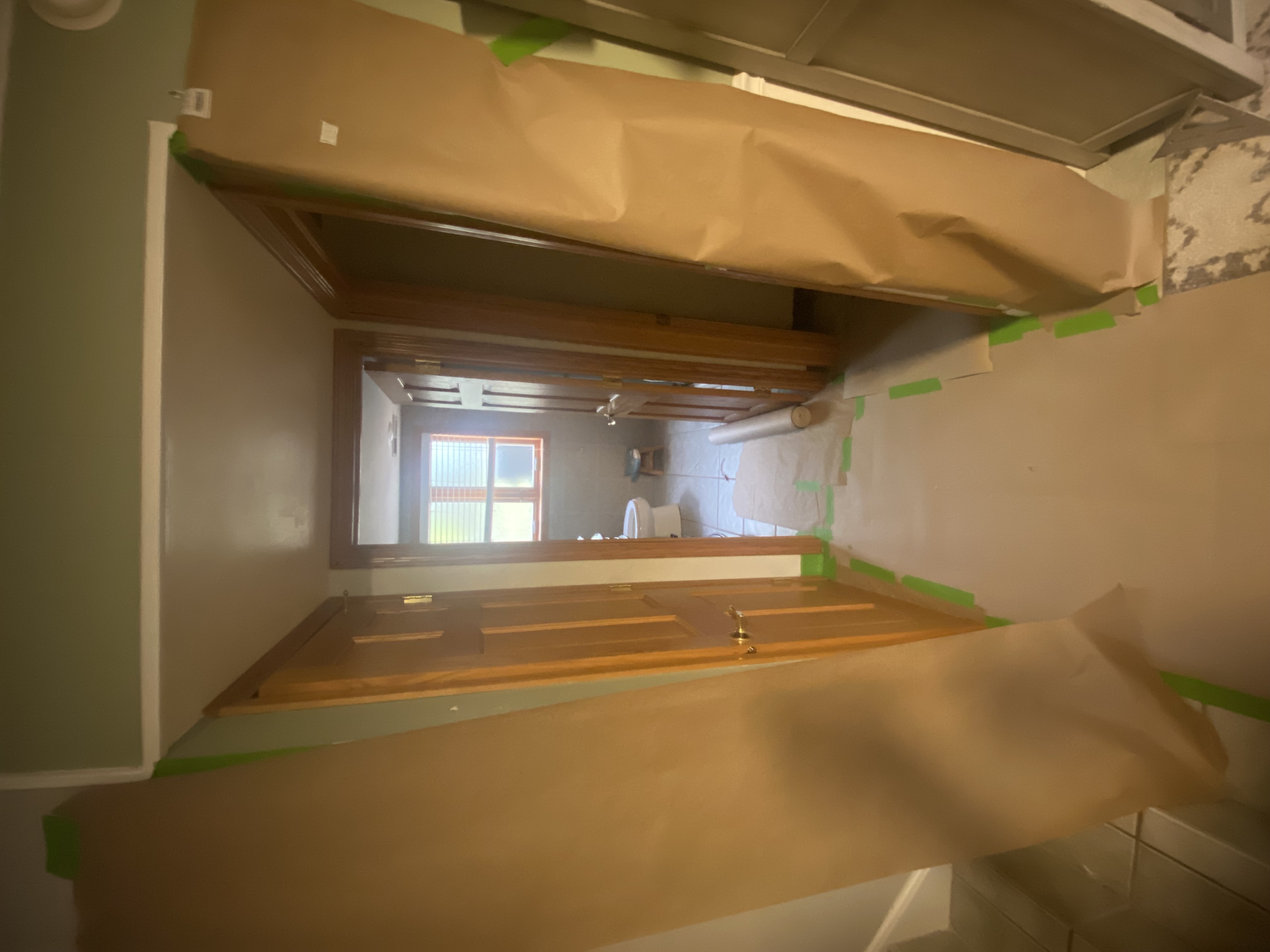 Hallway floors and walls protected with paper and tape during preparation