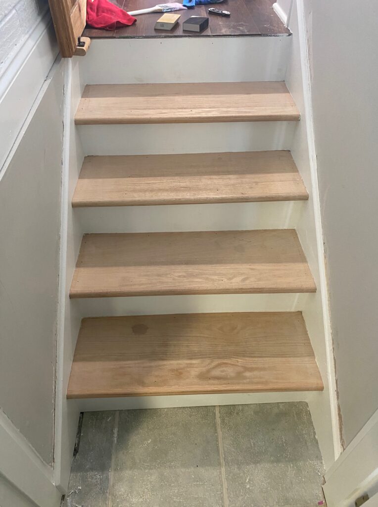 Bare wood stair treads before staining